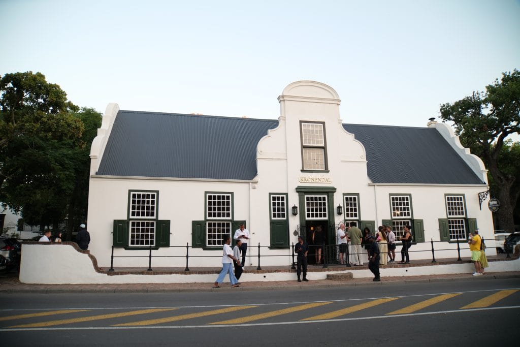 The front facade of Kronendal 1713 on Hout Bay Main Road, with the green shuttered front windows of the legend